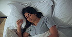 Above, woman and asleep in bed for nap, tired or fatigue with rest at home. Peaceful, calm and female person in bedroom sleeping for health, wellness and dreaming with comfort to relax at house