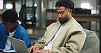Creative, man and typing on laptop in office for article research, editing blog post and planning. Media agency, content writer and happy on sofa for story development, draft review and publication