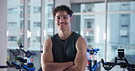 Arms crossed, face and fitness with man in gym for spin class, training or workout routine. Exercise, smile and stationary bike with happy athlete in health club for cardio, cycling or performance