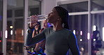 Bike, drinking water and fitness with woman in spin class for cardiovascular improvement at night. Exercise, performance and stationary spinning with thirsty athlete in gym for late evening challenge