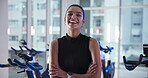 Arms crossed, face and fitness with woman in gym for spin class, training or workout routine. Exercise, smile and stationary bike with happy person in health club for cardio, cycling or performance