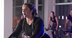 Cycling, class and woman in gym with trainer for cardio workout, exercise and training for strength. Sports, health club and people on bike machine for endurance, muscles and challenge for wellness