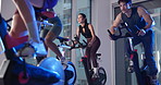Cycling, spin class and people in gym with trainer for cardio workout, exercise and training. Sports, health club and group on bike machine for endurance, core strength and challenge for wellness