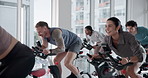 Class, stationary bike and people exercise for fitness, burn calories and lose weight for body health. Gym, happy group and indoor cycling for cardio training, laughing and leg strength for muscle
