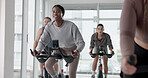 Fitness, people and spin class in gym for cardio exercise, endurance challenge or training. Group workout, indoor cycling and stationary bike with athletes in health club for performance or sports