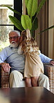Whisper, gossip and child with grandfather in home with bonding, love and connection together. Happy, rumor and kid with senior man for secret, news or question with shock in living room at house.