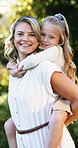 Piggyback, face or mom with girl in park for love, hug or bonding together with single parent. Portrait, safety or happy mother in nature with support, security or smile with kid on family holiday