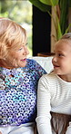 Relax, talk or grandma with girl in home for love, comfort or bonding together in retirement. Chat, senior woman or grandmother in lounge with support, care or smile with female kid in family house