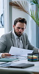 Office, reading documents and business man problem solving for accounting, payroll or investment. Paperwork, audit and serious corporate worker with financial revenue, stats and typing on laptop
