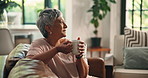 Home, daydreaming and woman with coffee, smile and drinking hot beverage in living room and morning. House, thinking and elderly person with warm tea in lounge, nostalgia or relax in weekend or break