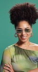 Happy, sunglasses and face of woman in studio for confidence, trendy clothes and style. Crossed arms, gen z and portrait of person with accessory for fashion, pride and aesthetic on blue background