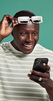 Surprise, fashion or black man with phone in studio for winning discount, sale or bargain deal. Wow, notification or excited person in trendy sunglasses, shock or cool clothes on green background