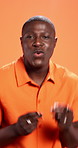 Face, dancing and black man in studio, happiness and movement on orange background. African person, excited and model with achievement, energy and celebration with music, winner and confidence
