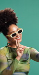 Selfie, peace sign and woman in studio, smile and confident personality on green background. Person, hand gesture and happy model with sunglasses, fashion and gen z with stylish clothes and emoji