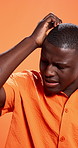 Confused, stress and black man in studio, scratch head and frustrated on orange background. African person, anxiety and model with conflict, mistake and reaction with doubt, thinking and brain fog