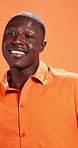 Dance, fashion and face of black man in studio for celebration, good news and success. Happy, excited and portrait of person with trendy style, joy and confidence on orange background with music