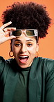 Shock, sunglasses and face of woman in studio for surprise reaction for sale, deal and bargain. Orange background, winning and portrait of person for omg, fashion news and discount announcement