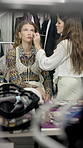 Women, makeup artist and brush in dressing room with foundation, application and face for fashion show. People, runway model and creative with tools, equipment and powder with cosmetics for beauty
