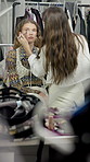 Women, makeup artist and brush in dressing room with powder, application and face for fashion show. People, runway model and creative with tools, equipment and foundation with cosmetics for beauty