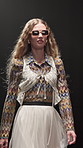 Fashion week, woman and walk with sunglasses on runway for clothes showcase, retro or vintage style. Catwalk show, model and couture wardrobe on stage for designer collection, brand design and event