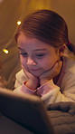 Girl, child and watching with tablet at night for entertainment, fairy tale or story in bedroom. Kid, relax and late evening with technology or lights for animation, cartoon or movie in bed at home