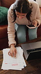 Woman, finance and phone in home with paperwork, debt management or fintech for easy payment on sofa. Person, smartphone and mobile app with documents, bills and laptop for credit score at apartment