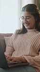 Woman, laugh and relax with laptop on sofa in home with typing, search or funny post on web in lounge. Person, computer and happy with click, comic video and comment on social media at apartment