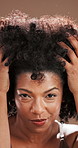 Haircare, growth and woman with afro, face or treatment for texture of natural hair, happy or shine. Studio background, confident or black person with smile for hairstyle, glow or cosmetic for beauty