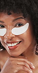 Woman, face and eye mask for skincare, beauty and smile with facial cosmetics for wellness. Happy, patches and treatment for dark circles, dermatology and African person with hands for skin glow