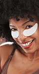 Skin care, eye patch and face of african woman in studio for dark circle rejuvenation, glow or detox. Happy, girl or natural model for dermatology, facial hydration mask and collagen for beauty