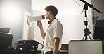 Filming, production and megaphone with man on set for shooting, director and schedule. Crew supervisor, backstage and cinematography plan with person in studio for speaker, performance guide and media