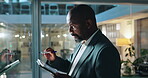 Tablet, planning and glass with business black man in office for attorney research, legal aid or night. Lawyer, online advocate and writing with person and wall in law firm for overtime on court case