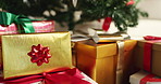 Christmas, tree and gifts with boxes or ribbon for festive or december holiday celebration in home. Closeup, decorations or presents with surprise for new year, santa or christian tradition in house