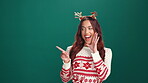 Pointing, announcement and woman with smile, studio and excited for holiday offer or festive season. Happy, face and person with hand gesture for discount, mockup space and good news for Christmas