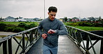Running, check time and man in city, fitness and energy with challenge, wellness and cardio. Outdoor, person and runner with practice, workout and health with endurance, progress and training info