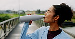 Runner, fitness and woman drinking water on bridge for running break, hydration and thirsty. Exhausted, athlete and liquid bottle outdoor for training refresh, exercise recovery and workout fatigue