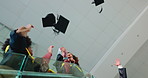 Students, hands and throw with graduation cap, celebration and success with education on stairs. People, group and goals with hat, scholarship and achievement at university campus from low angle