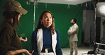 Makeup, script and styling with annoyed actress behind the scenes for film or production stress. Frustration, media and videography on green screen with woman speaking to stylist for studio concern