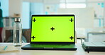 Laptop, green screen and mockup in office with tracking markers for business website on desk. Computer, workspace and display for marketing, advertising and branding with information on internet