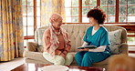 Tablet, senior woman and talking to nurse in home for health improvement, patient records or laugh. Tech, caregiver and happy person in retirement for treatment results, medical update or good news