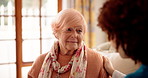 Nurse, advice and old woman with empathy in home for healthcare support, listening and diagnosis. Homecare, caregiver or senior patient with health consultation on sofa for medical results or comfort