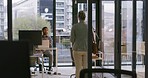 Rear view of a young businesswoman late for an interview with an annoyed looking employer in a modern office