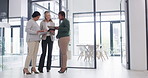 Businesswomen talking about an innovation strategy together as a team on a tablet after a collaboration meeting in a modern office. Female executives in a group discussion about a new brand project