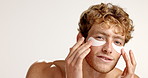 Face, man and eye mask for skincare, beauty or dermatology on white studio background. Apply, happy model and facial patches for hygiene, glow and hydration treatment with cosmetics for collagen