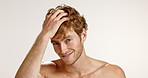 Face, man and smile for haircare, studio and confident with cosmetics for healthy hair or treatment. White background, grooming and person with pride for texture, mockup space and growth of hairstyle
