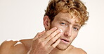 Skincare, cream and beauty with face of man in studio for hydration, self care and facial treatment. Dermatology, collagen and glow with person and lotion on white background for shine and grooming 