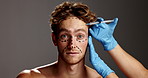 Man, face and needle for plastic surgery in studio with lines, aesthetic or dermatology by background. Person, cosmetic surgeon and syringe for skin, portrait or filler with mockup space in Argentina