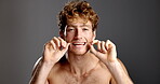 Studio, man and face with floss for dental care, hygiene and grooming for teeth whitening with smile. Mockup space, male person and portrait with string for wellness, tooth health and gray background