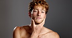 Face, skincare and man in studio for glow, shine and beauty on gray background. Portrait, grooming and touch with model for hydration, collagen treatment and wellness with cosmetics for dermatology
