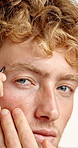Tweezer, eyebrows and face of man in studio with grooming, epilation and facial routine for maintenance. Portrait, plucking and person from Australia with hair removal treatment for transformation.